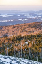 View from Mount Lusen over the hills of the bavarian forest at sunrise in winter, Bavaria, Germany