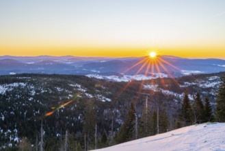 Sunrise over the hills of czech republic from Mount Lusen wth the view over the hills of the