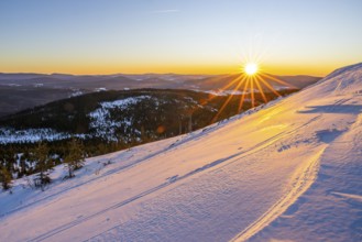 Sunrise over the hills of czech republic from Mount Lusen wth the view over the hills of the
