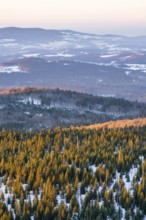 View from Mount Lusen over the hills of the bavarian forest at sunrise in winter, Bavaria, Germany