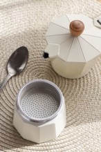 Geyser coffee maker, empty and clean, disassembled on the table, coffee preparation, sunlight,