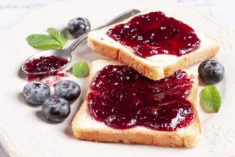 Toast with blueberry jam, on a white plate, breakfast, top view, homemade, no people