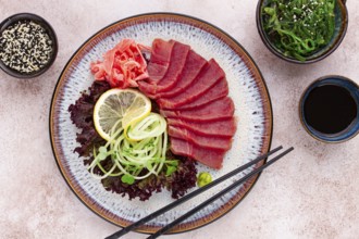 Freshly prepared sashimi with vibrant garnishes served on a decorative plate
