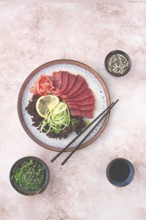 Freshly prepared sashimi with vibrant garnishes served on a decorative plate