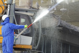 Demolition work in building construction. water jet against dust and dirt. Paderborn, North