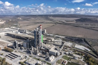 Aerial view of a sprawling industrial complex with rural fields in the background. Aerial view to