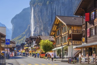 Village road with Staubbach waterfall, Lauterbrunnen, Bernese Oberland, Canton of Bern, Switzerland