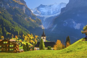 Village church in the town center with fieschörner 4049m in autumn, Grindelwald, Lütschinental,
