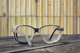 Filtered picture of a vintage safety glasses on a wooden table Prague Czech republic