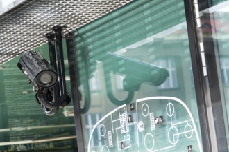 Security camera hanging down mounted on pole on the building facade Prague Czech republic