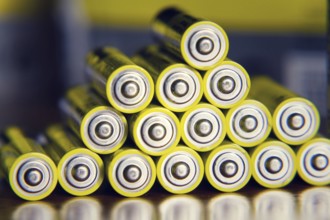 Stack of yellow AA batteries close up abstract color background Prague, Czech republic