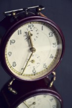 Filtered picture of a vintage alarm clock on a mirror backgroud Prague Czech republic