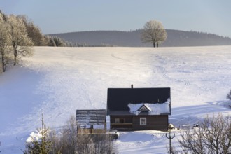 Timbered cottage in frosty mountains country in sunny winter day Neratovice Czech republic