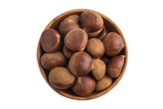 Wooden bowl with raw edible ?hestnuts Isolated on white background, top view, flat lay, close up,