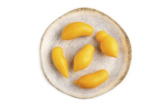 Yellow tomatoes on plate isolated on white background. Top view, flat lay, close up. healthy food,