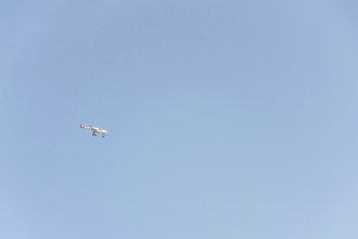 Unmanned aerial vehicle surveillance drone with light and camera flying, sunny summer day, drone