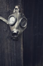 Closeup of a gas mask on a wooden background