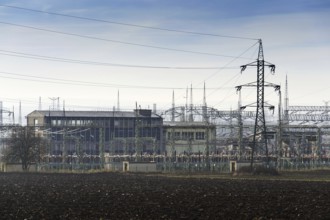 Distribution power station with electricity pylons and dramatic cloudy sky background Prague Czech