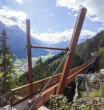 View of Neustift and Stubai Glacier from suspension bridge on the Sunnenseit'n-Weg hiking trail in