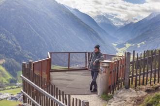 Hikers on a viewing platform near the suspension bridge on the Sunnenseit'n-Weg hiking trail, in