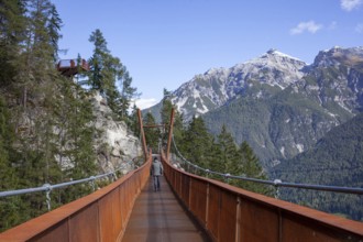 Mount Serles with suspension bridge on the Sunnenseit'n-Weg hiking trail, in autumn, Neustift im