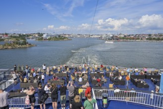 Passengers at the stern, Viking Line XPRS ferry leaves port, Helsinki, Finland