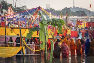 Hindu devotees gather on the banks of the Brahmaputra River to offer prayers to the Sun God on the