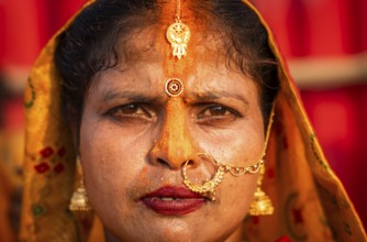 A Hindu devotee offer prayers to the Sun God on the bank of Brahmaputra river on the occasion of