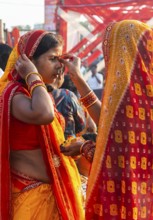 Hindu devotees gather on the banks of the Brahmaputra River to offer prayers to the Sun God on the