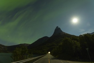 Magical Stetind mountain in northern Norway under auroras and full moon
