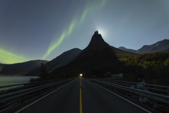 National mountain of Norway, Stetind in the Nordland under auroras and a full moon behind the