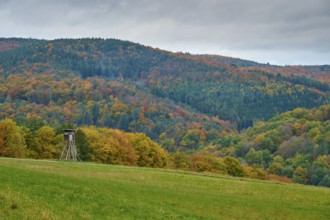 Autumn landscape with hunting pulpit, colorful forests and hills under cloudy sky, autumn,