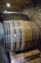 Two large wooden barrels in a cellar with rustic stone walls, Hin Areni Winery, Areni Village,