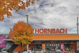 Autumn-colored maples (Acer), and entrance to Baumarkt-hornbach, Kempten, Swabia, Bavaria, Germany