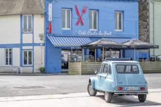 Parked sky blue Citroen 2CV with roll top in front of Café Resto du Port Le Surcouf, a popular