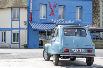 A sky blue Citroën Dyane or 2CV with roll top is parked in front of the bright blue Café Resto du
