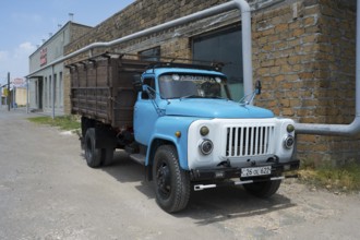 Old blue truck in front of a brick wall in an urban environment, GAZ-53 truck, Ararat, Ararat