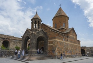 Historic church building with dome, people on a wide path in front of it, Khor Virap monastery,