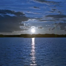 Atmospheric moonrise over Lake Gudelack, Lindow (Mark), Stechlin-Ruppiner Land nature park Park,