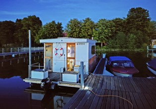 Houseboat at dusk at Marina Lindow (Mark), Gudelacksee, Stechlin-Ruppiner Land nature park Park,