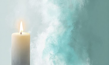 A candle is lit in front of a blue background. The candle is the main focus of the image, and it