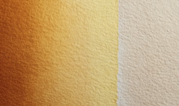 A tan and gold wall with a slightly darker shade of tan. The wall appears to be made of a textured