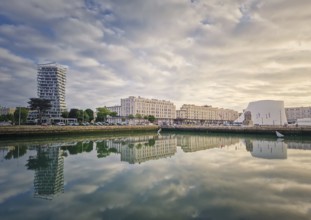 Beautiful waterfront scene in Le Havre, France at sunset. Buildings are perfectly reflected in the