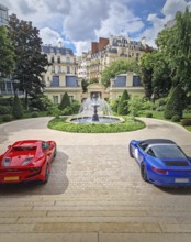 Two luxury sports cars parked in the driveway of an opulent Parisian mansion with view to a
