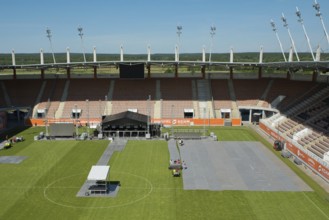 LUBIN, POLAND - JUNE 09, 2017: Workers laying protection on the grass at the stadium before Cuprum