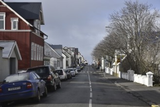 REYKJAVIK, ICELAND - MARCH 12, 2017: Street in Reykjavik with cars and houses