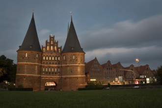 LUBECK, GERMANY - AUGUST 3, 2016: Holstentor Gate during twilight. Lubeck old town is on a UNESCO