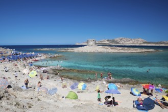 STINTINO, ITALY - AUGUST 21, 2017 - Unidentified people in the sun on the famous La Pelosa Beach on