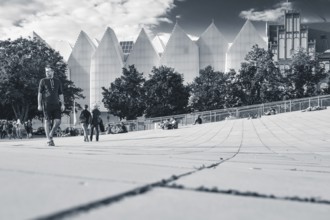 SZCZECIN, POLAND - AUGUST 6, 2017: Passers-by on the pedestrian zone and the Philharmonic building
