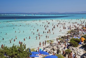 STINTINO, ITALY - AUGUST 21, 2017 - Unidentified people in the sun on the famous La Pelosa Beach on